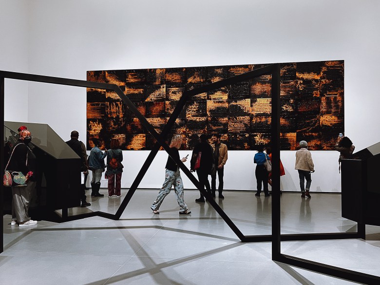 A photograph of visitors at the Baltimore Museum of Art viewing two large scale artworks. 