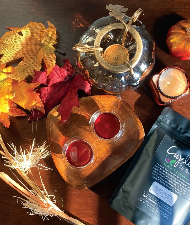 A color photograph of a fall tablescape and a bag of tea. 