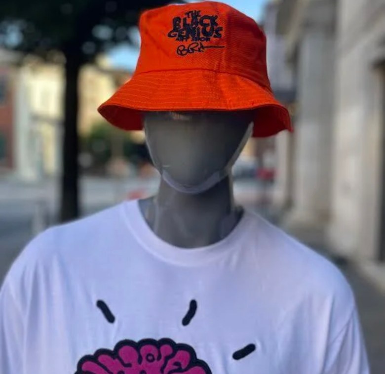 A photograph of a mannequin wearing a hat and t-shirt. 
