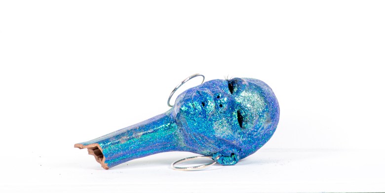 A sculpture covered in blue glitter. 
