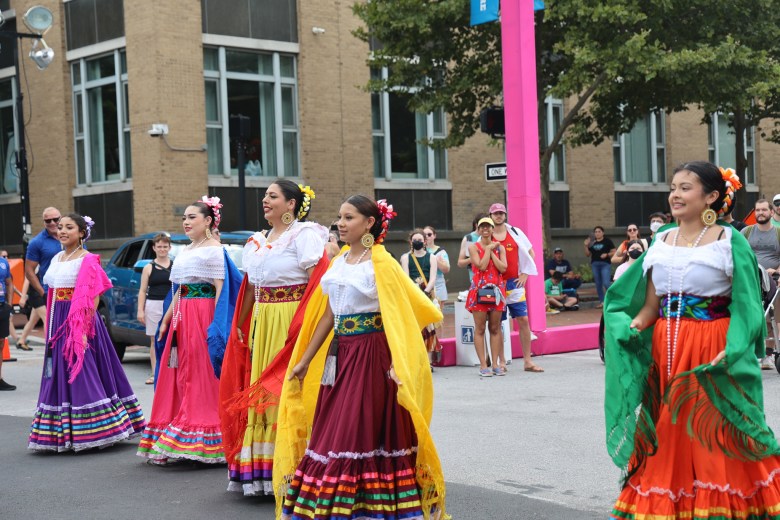 Dancers in brightly colored outfits. 