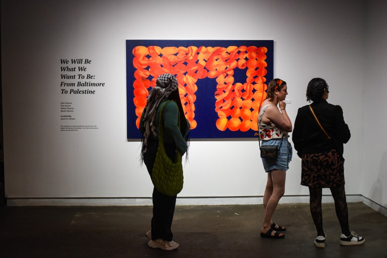 Photograph of a group of people looking at an art exhibition 