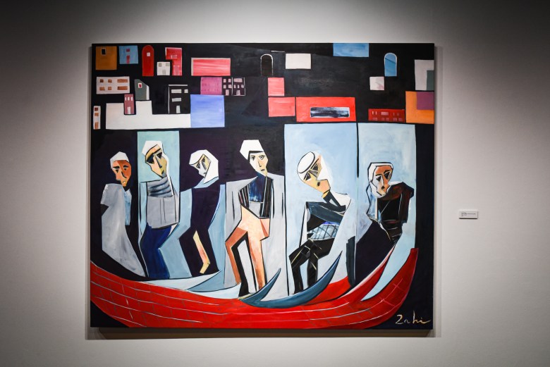photo of a large colorful cubist painting installed on a wall. 