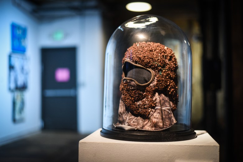 photo of an art object which is encased in a glass dome. 
