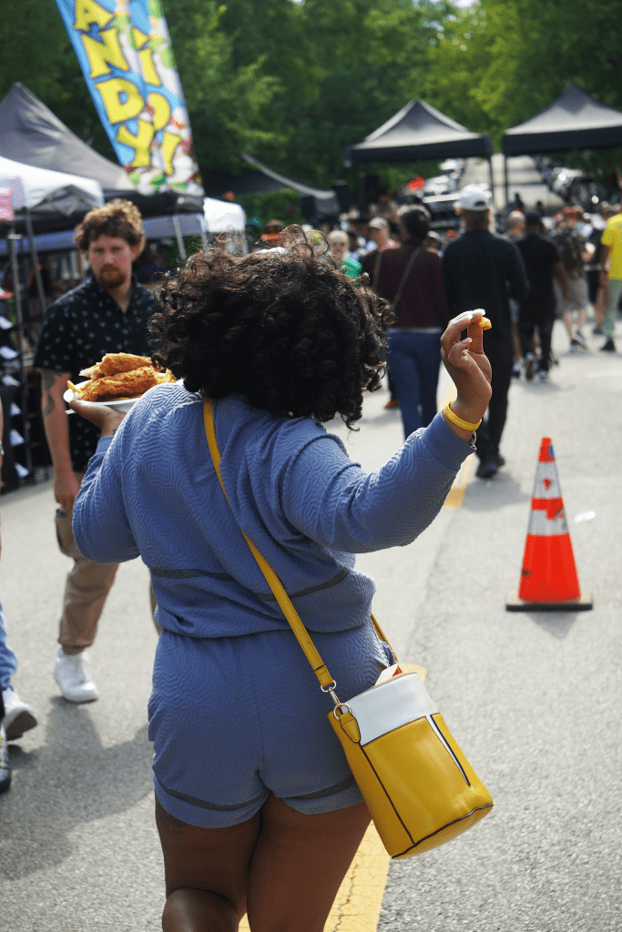 A shot of a person holding a plate of food as they walk away.